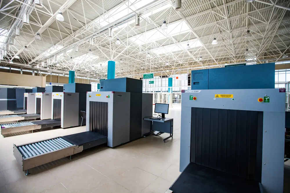 Scanners à rayons X alignés dans un aéroport pour le contrôle douanier du fret et des marchandises de transit.